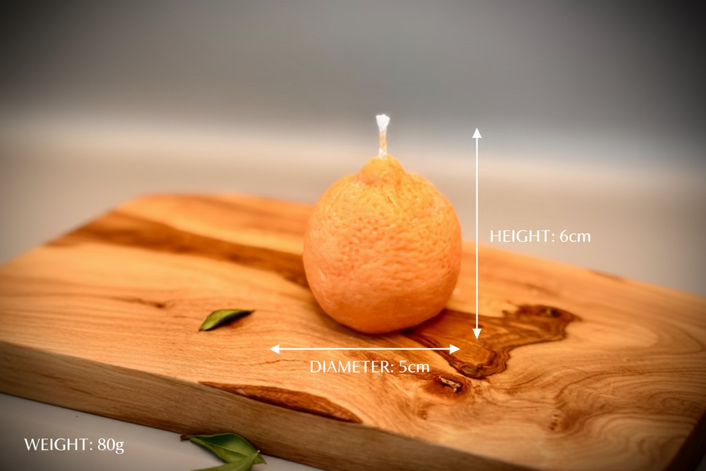 Orange candle on a wooden surface with a blurred background